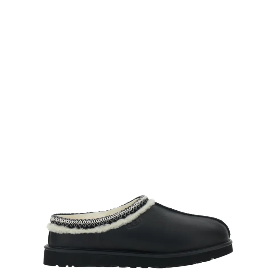 Svarte skinnmules med preget logo